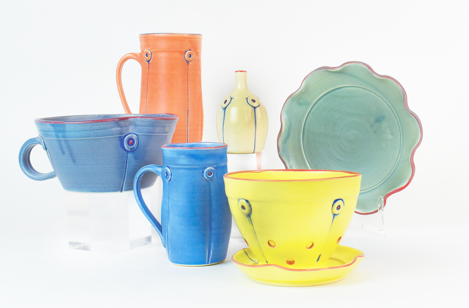 Collection of whimsical and colorful pottery by artist Rebecca Lowery